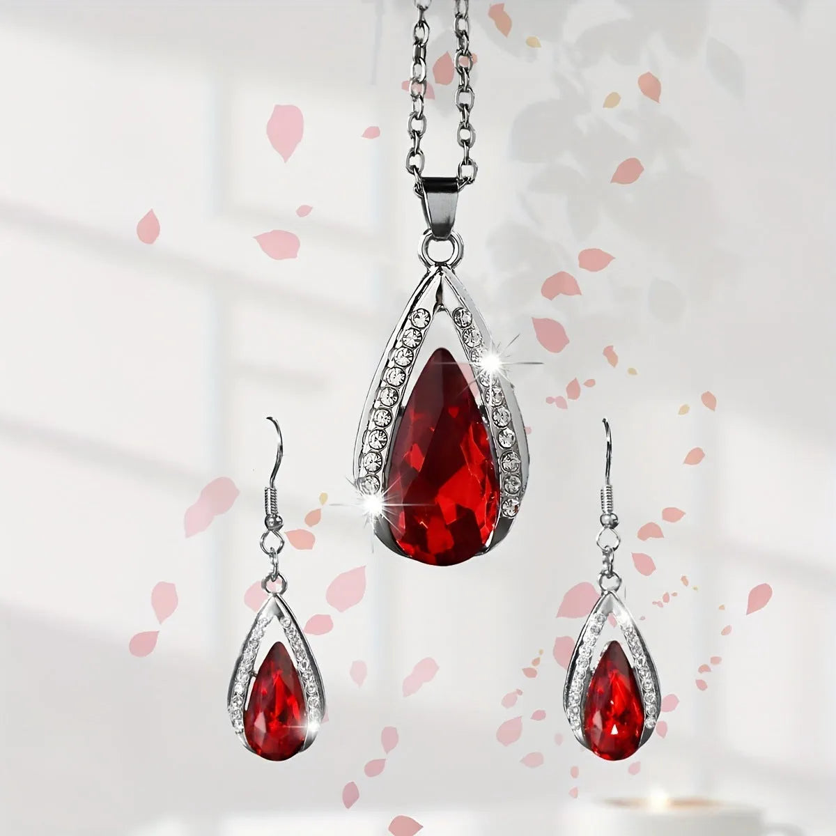 Black and red teardrop pendant alloy necklace and matching earrings set on a white background.