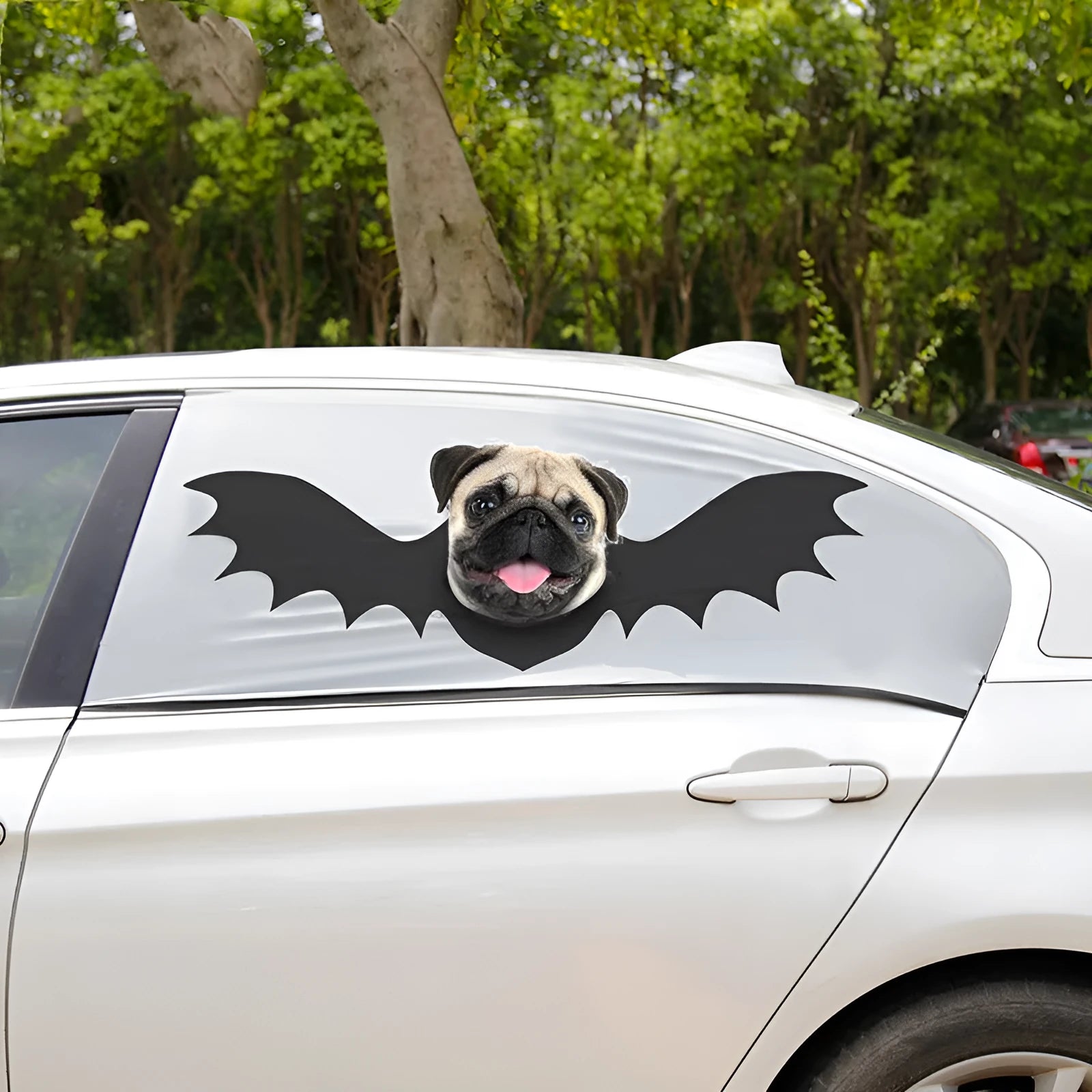 Grey car sun shade curtain with bat pattern and central head hole for dogs, installed on a car window