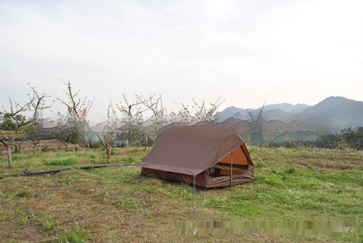 Brown A-line tent for 2-3 people with PU4000 waterproof fabric, 210x150x110cm, set in a grassy campsite.