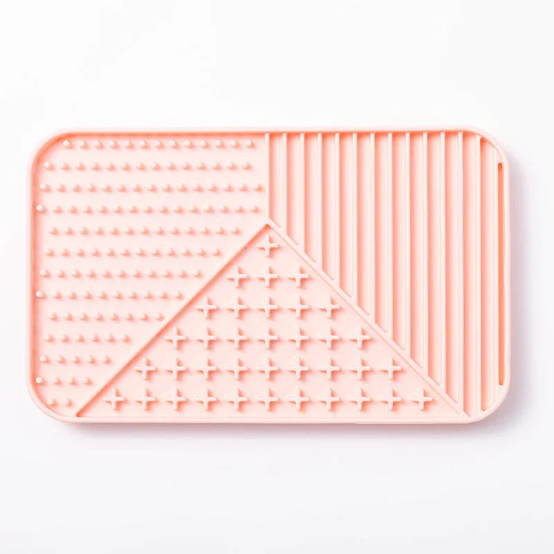 Silicone pet licking mat with textured surface and suction cup base in pink colour
