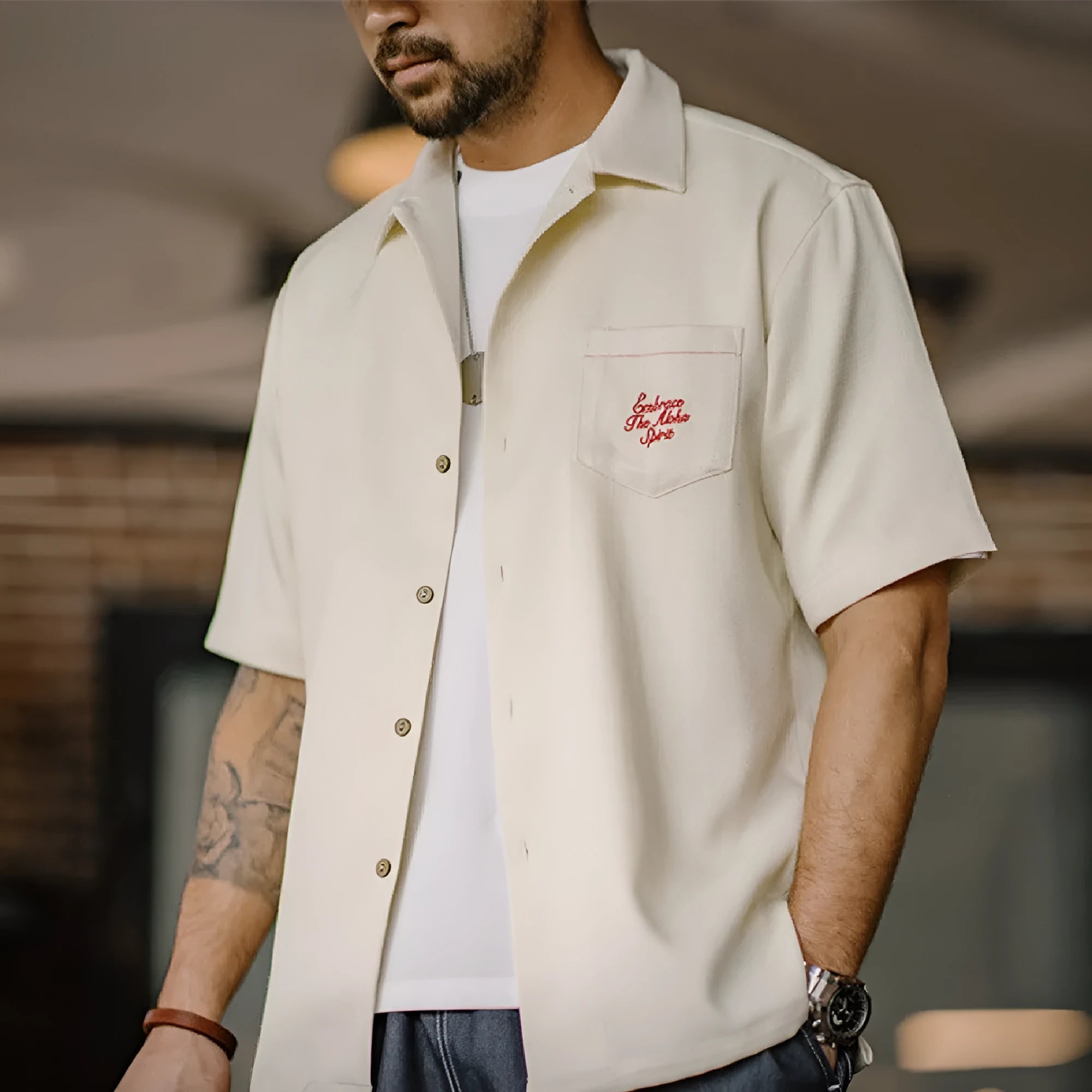 Light apricot men's Cuban collar shirt with bamboo and floral plant pattern.