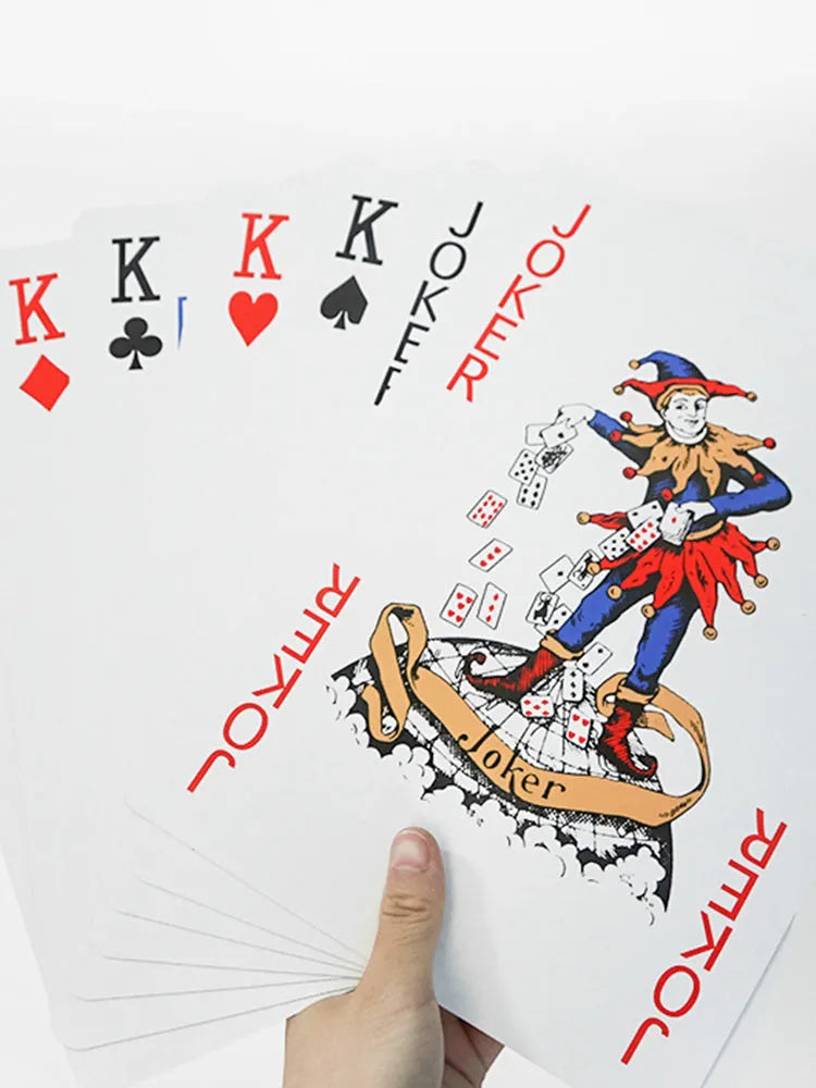 Set of oversized large size paper playing cards laid out on a table, showing the full 54-sheet deck.