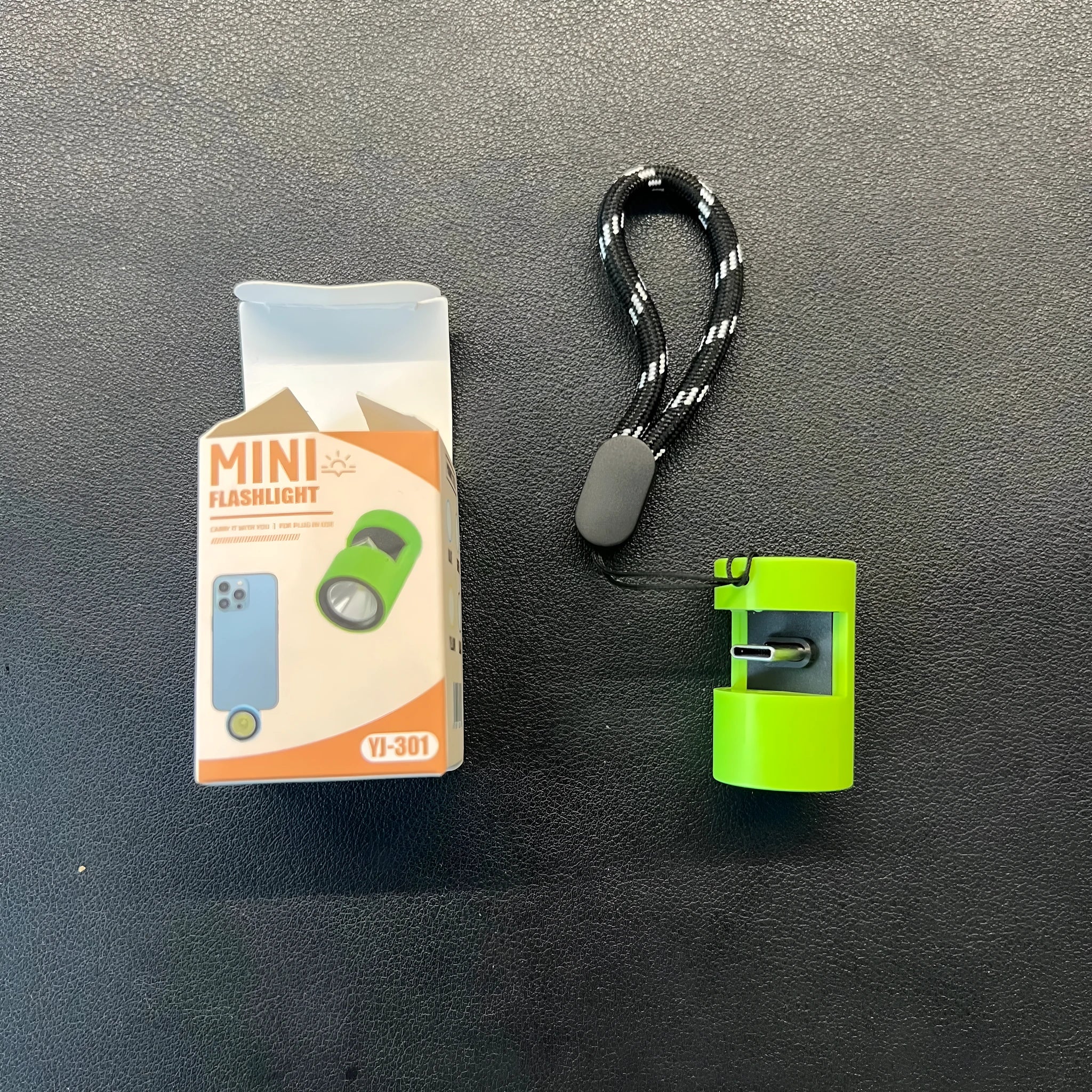 Green mobile phone mini torch with Type-C interface and LED light wick on a keychain