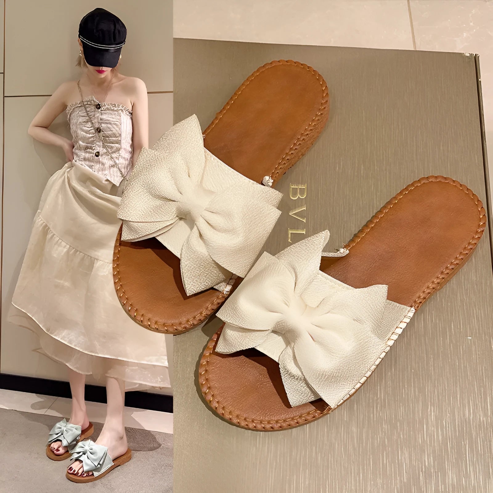 Women's beige slip-on suede sandals with a flat rubber sole and a small bow detail on the upper.