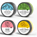 Set of four 80ml clay face mask jars: Dead Sea mud, green tea, turmeric, and rose formulas.