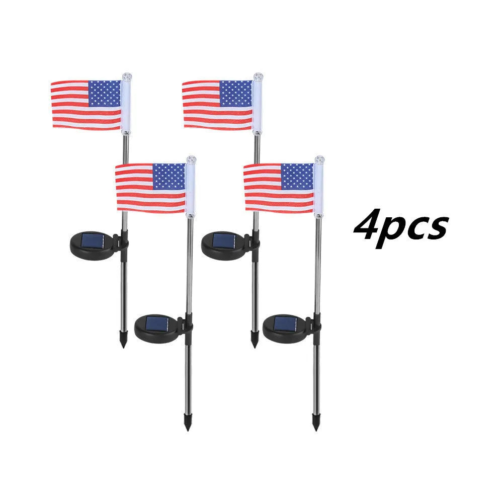 Solar-powered stainless steel garden flag light showing American flag design with white LEDs illuminated.