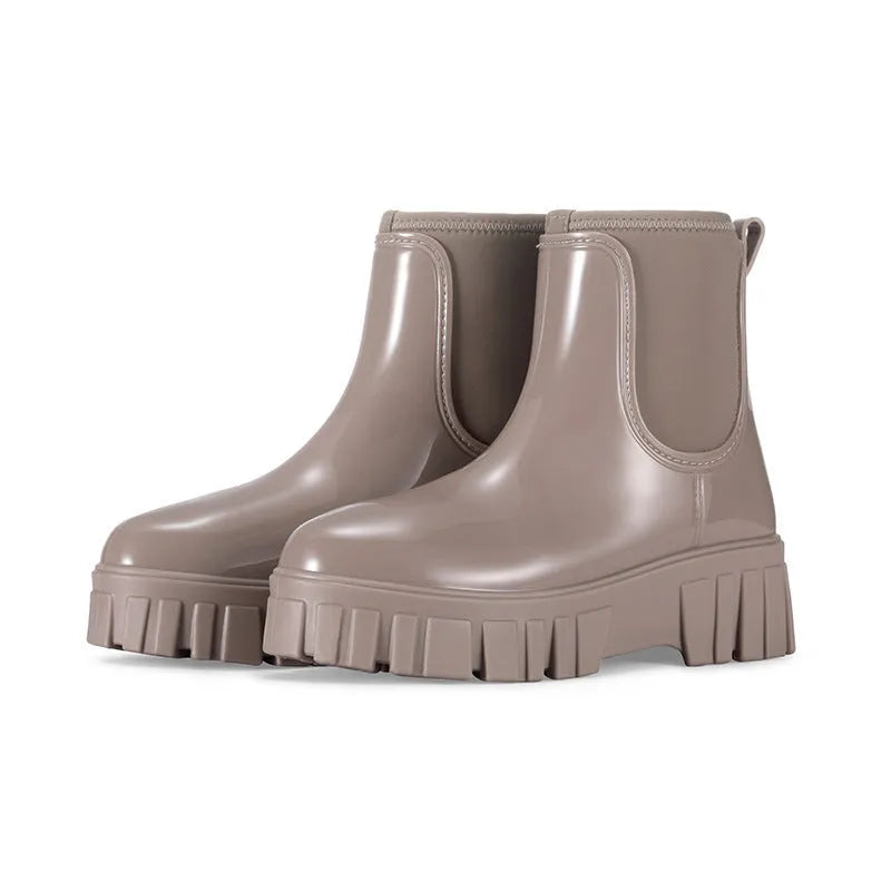 A pair of low tube PVC rain boots with a flat heel, shown in a solid colour on a white background.