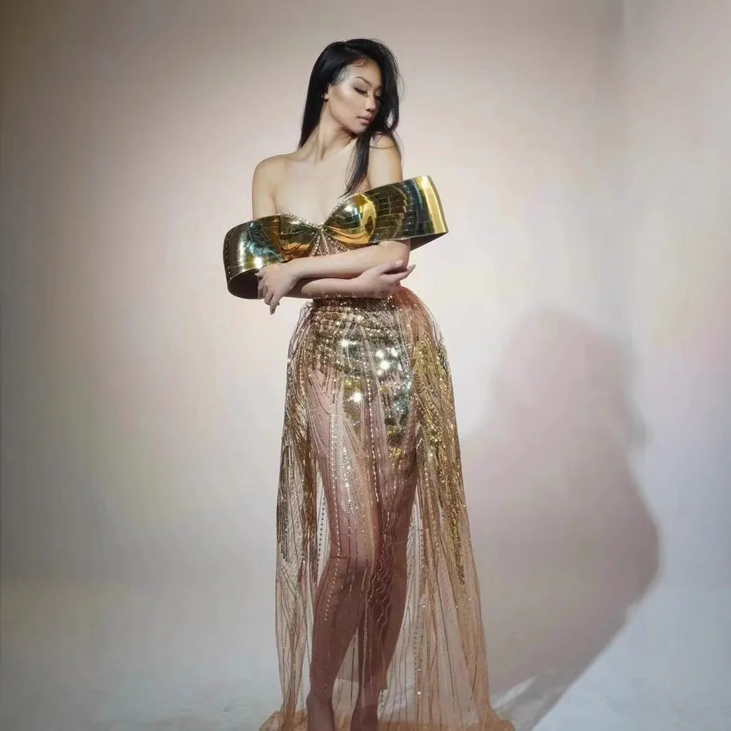 Gold metallic strapless dress with sequin details and a full tulle skirt featuring a high split.