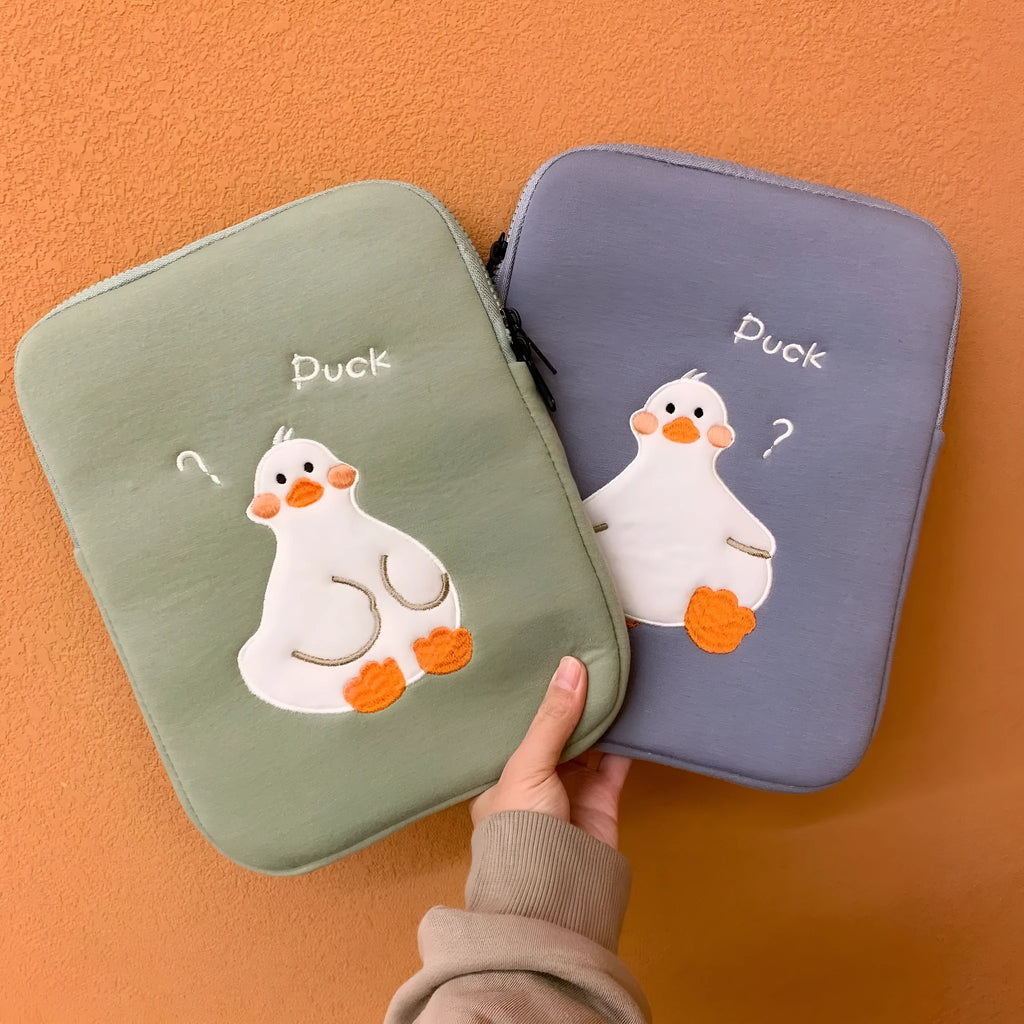 Blue cotton tablet case with cartoon duck embroidery and a zipper closure.