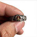 Hand-forged copper Grotto Buddha ring with rock texture on a size No. 8 finger.