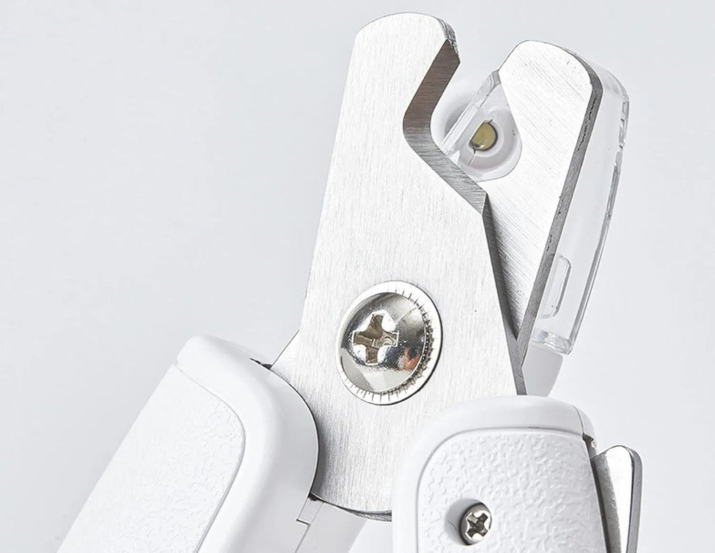 White LED pet nail clipper for cats and dogs with transparent anti-splash guard and file.