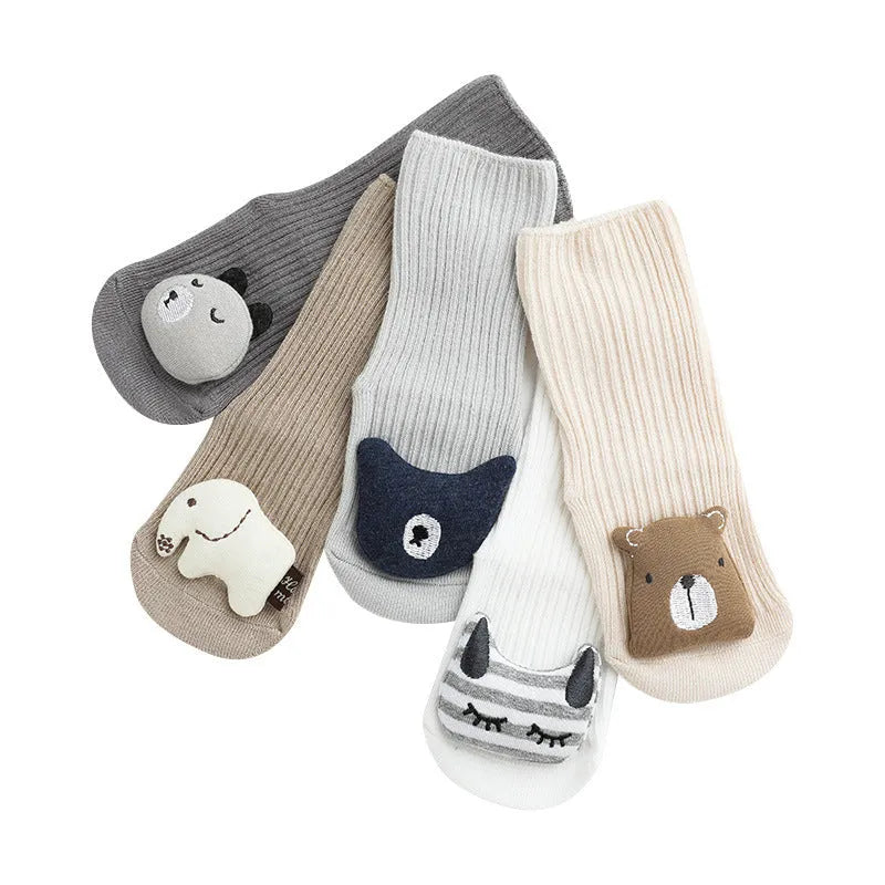 Baby socks with non-slip rubber grip soles on the feet, shown in a light grey colour.