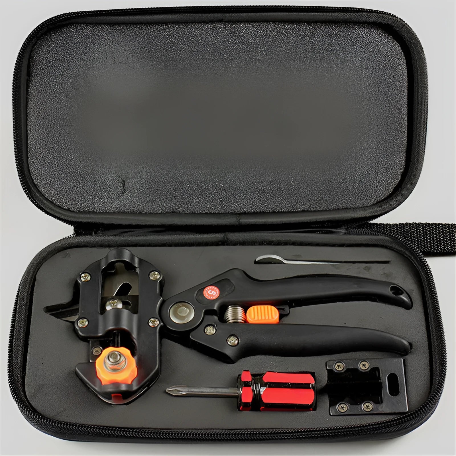 Black handheld grafting scissors with high carbon steel blade and ABS handle on a wooden surface
