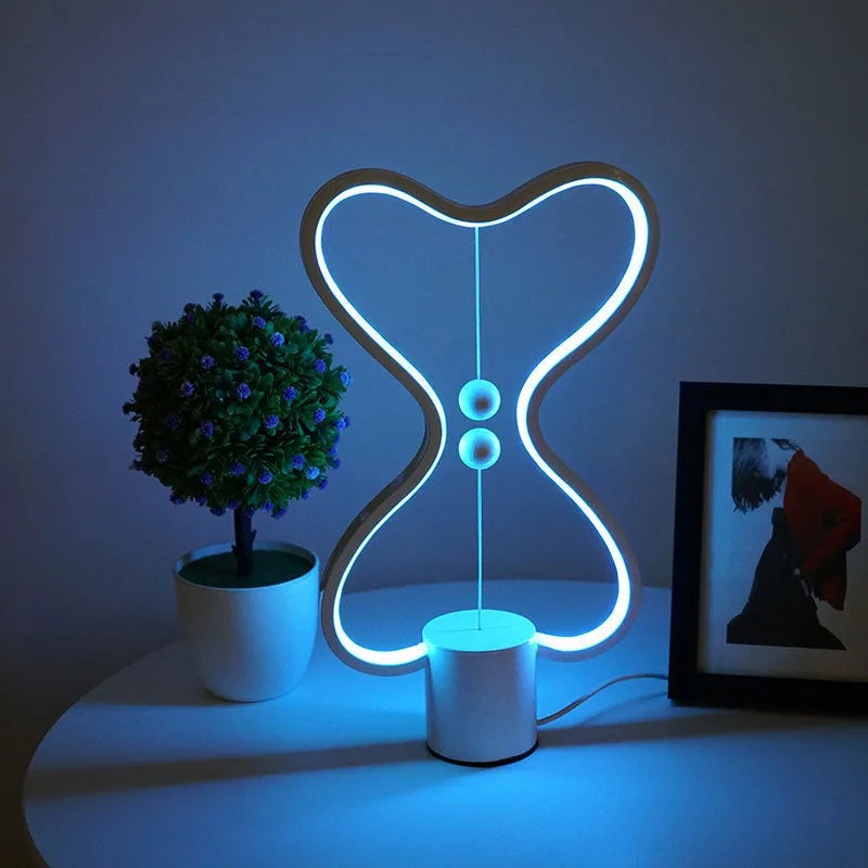 7-colour balance LED night light with magnetic suspension, USB powered, on a desk showing warm white glow