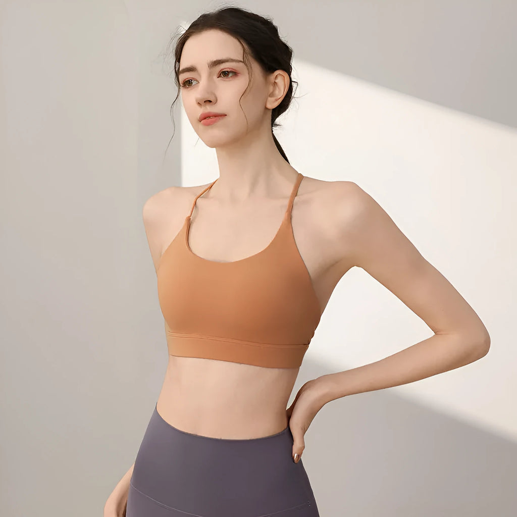 Women's nylon sports vest with fixed double-shoulder straps on a hanger