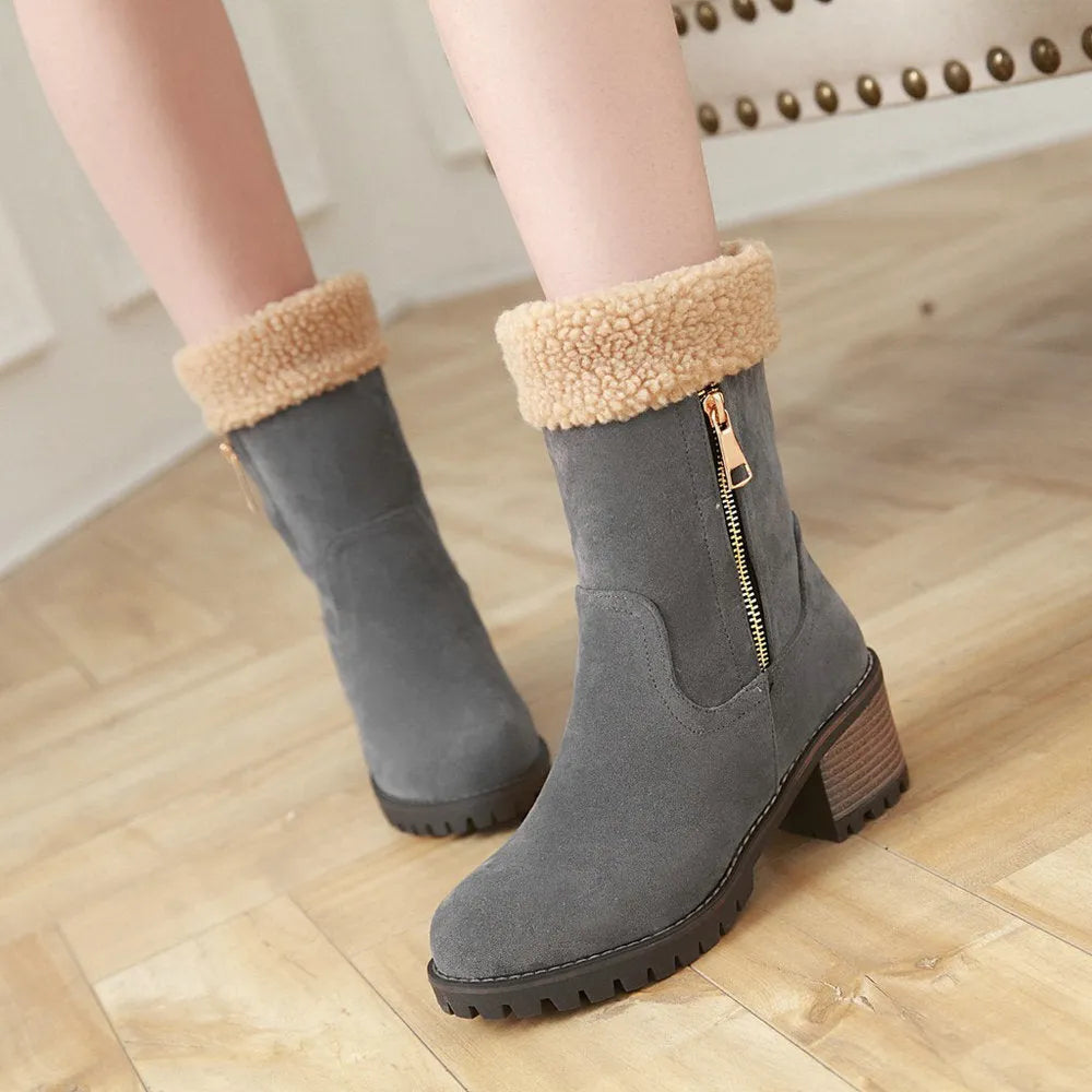 A pair of snow boots in black, grey, green, or orange with a rubber sole and plush lining.