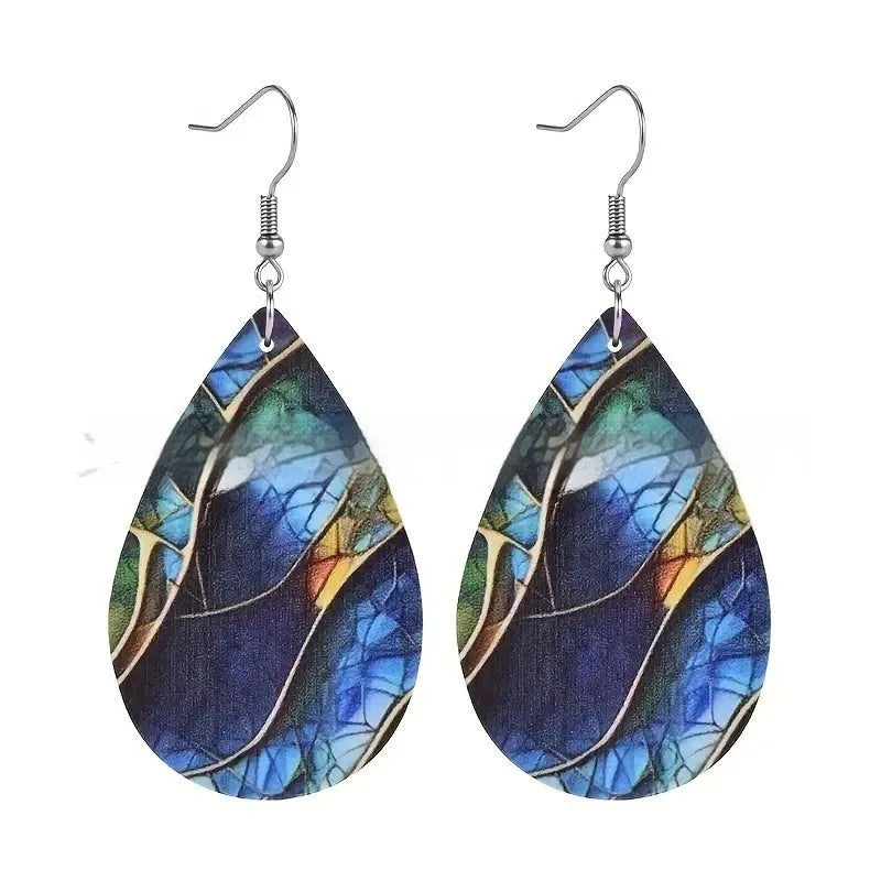 A pair of printed acrylic drop earrings with a flat branch knot design.