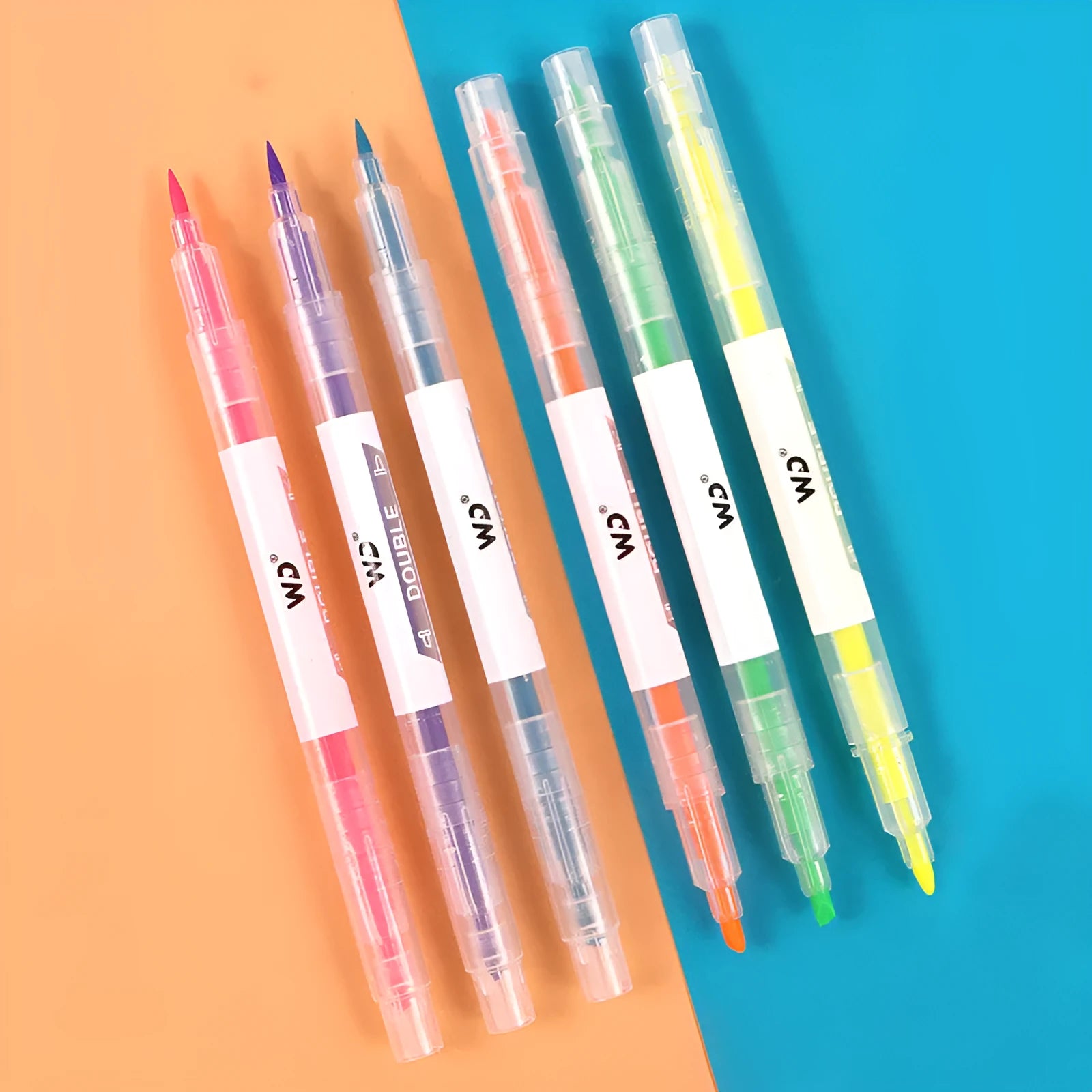 Six double-headed highlighter pens showing round and oblique nibs in orange, purple, yellow, green, blue, and pink colours
