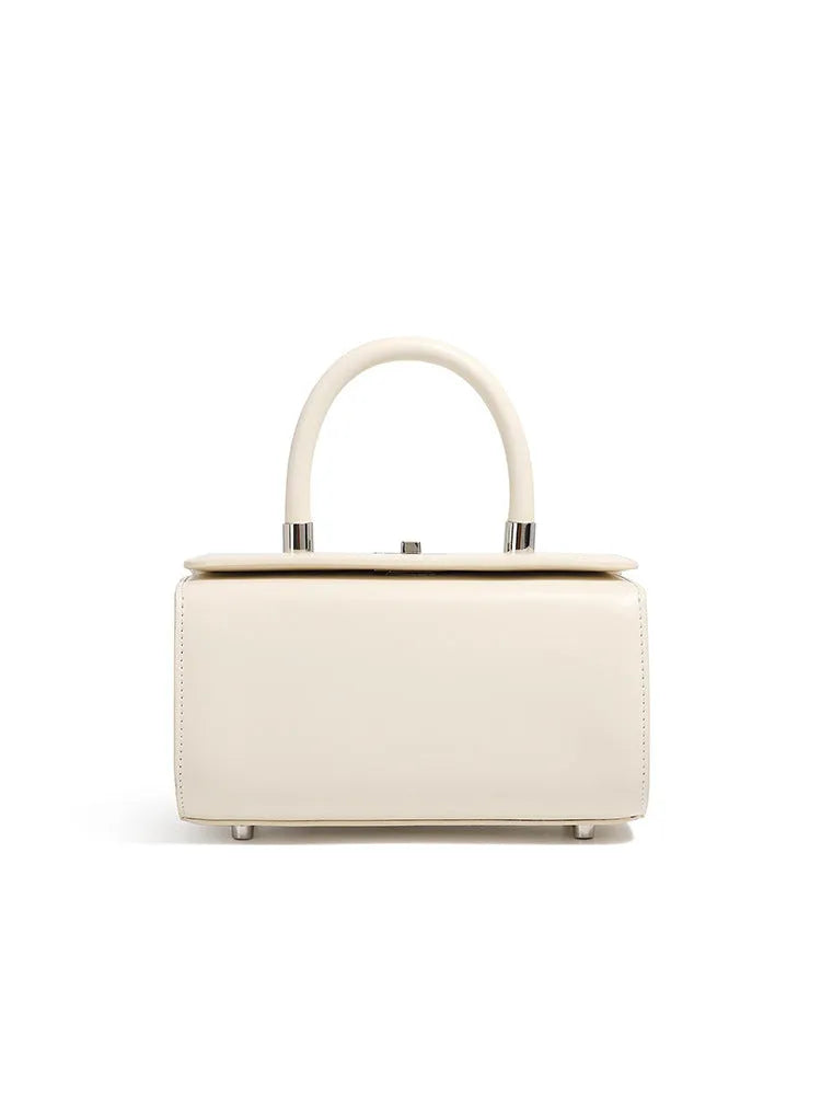 Women's leather crossbody bag in clamshell design showing internal phone and file pockets.