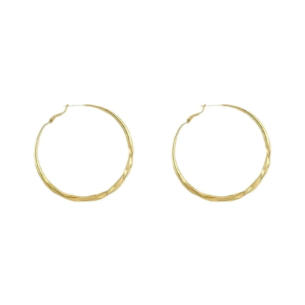 Twisted eyelet simple metal earrings in 3499 Gold and 3499 Silver on neutral background