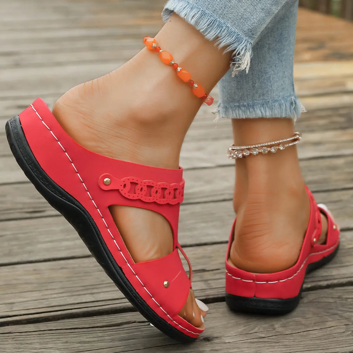 Blue Roman style slippers with a fish mouth toe holder and slope heel on a rubber sole.