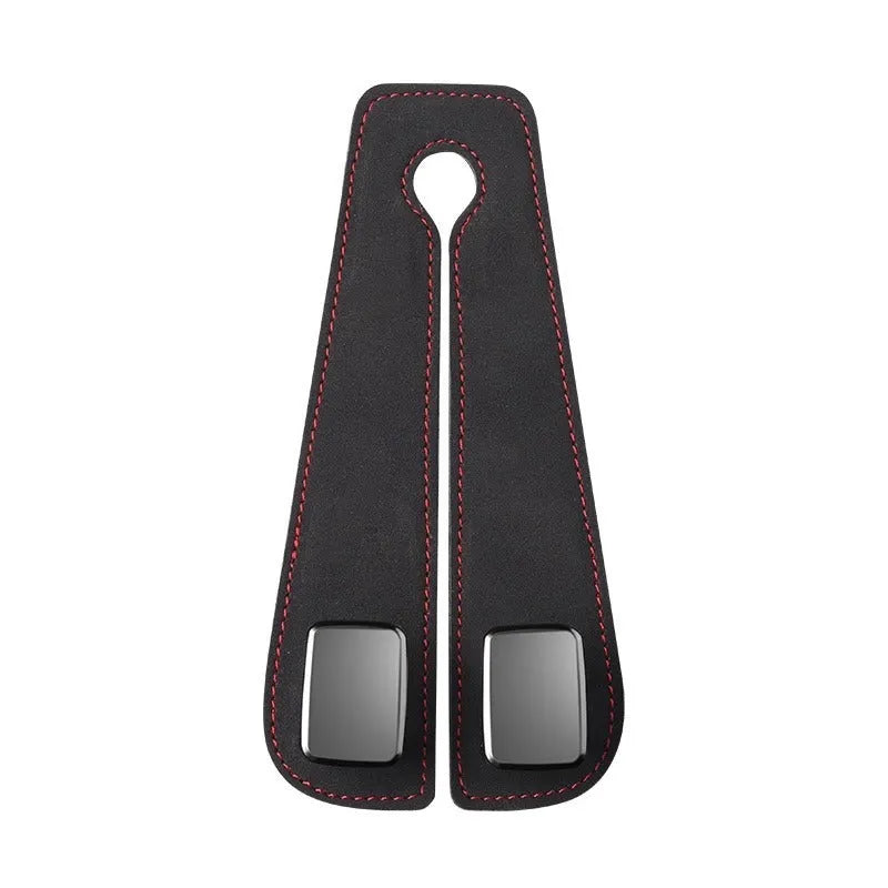 Black suede and metal car seat hook organiser hanging on a car headrest.