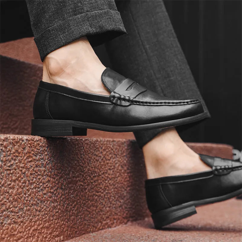 Men's black casual slip-on leather shoes with soft bottom and sewing line detail on a clean background