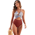 Women's black one-piece swimsuit with a colourful patchwork leaf print pattern