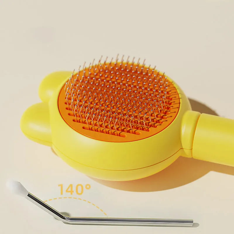 Green self-cleaning pet brush with a metal comb, release button, and comfort-grip handle for grooming cats and dogs.