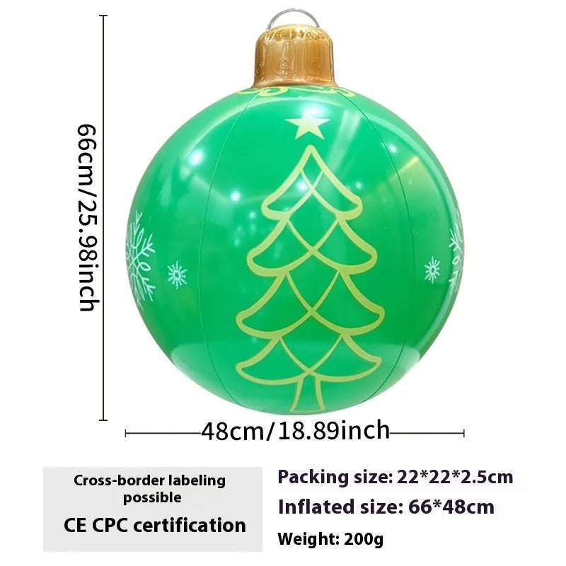 Large red inflatable Christmas ball with flashing lights displayed on a winter garden lawn.