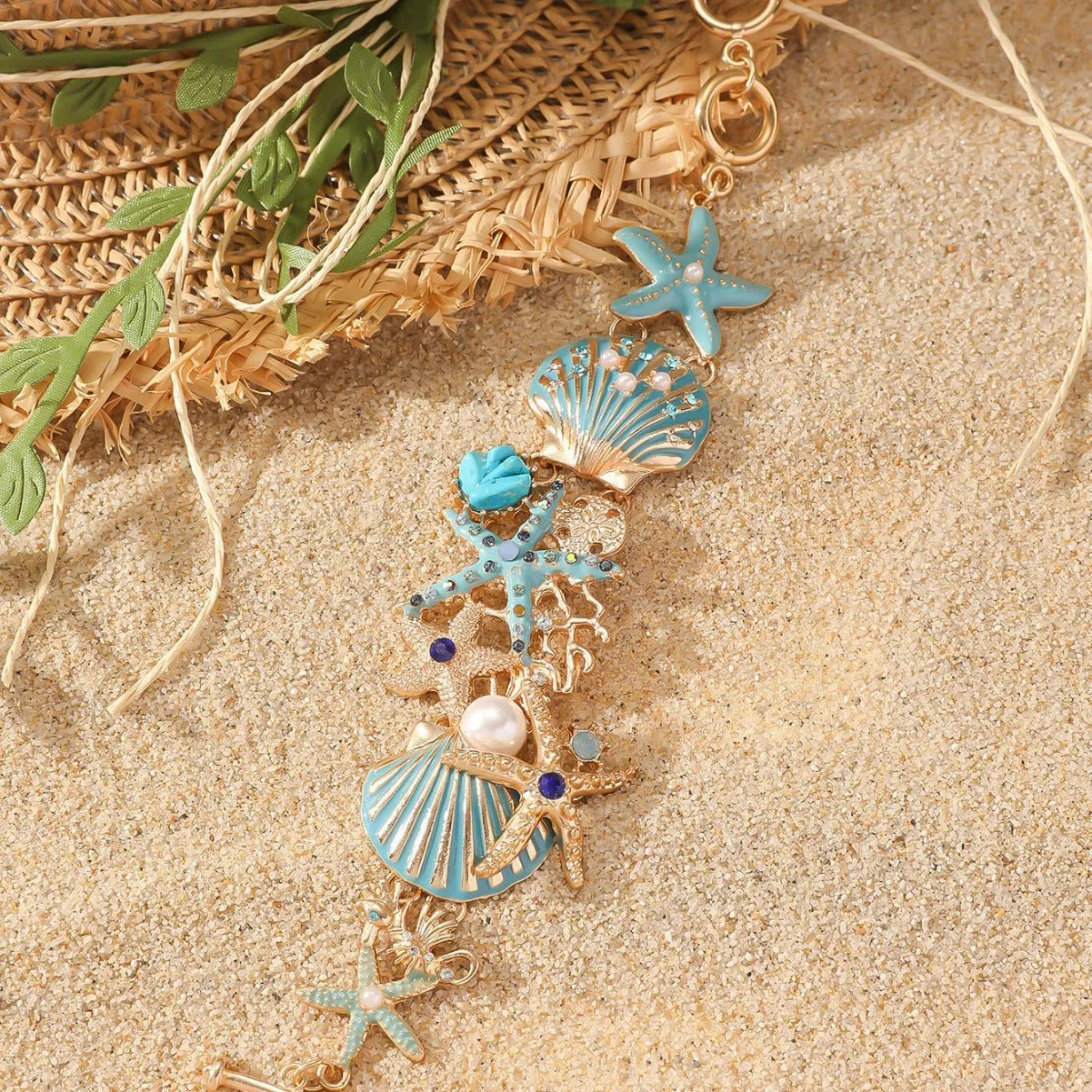 Alloy rhinestone bracelet with boat anchor and starfish design in turquoise, coral red, or coral blue.