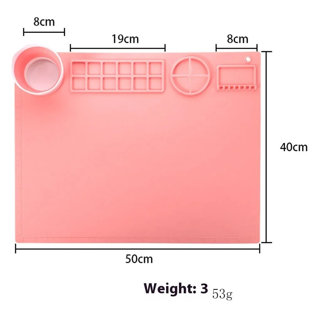 Light blue silicone painting mat with two moulded bowls for artists, size 50cm by 40cm.