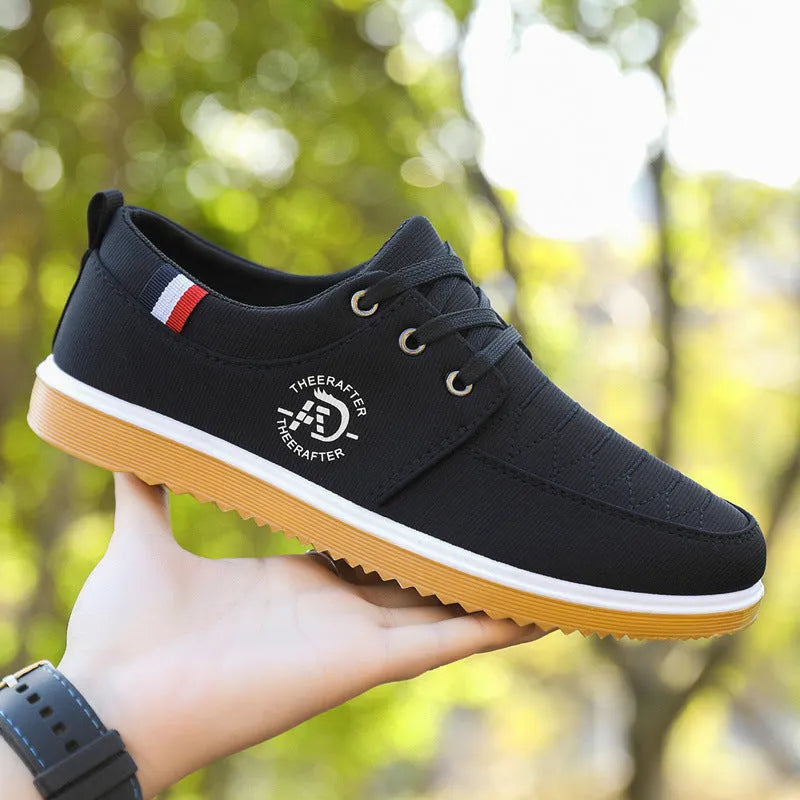 Men's black canvas casual shoes with a leather toe cap and platform sole.