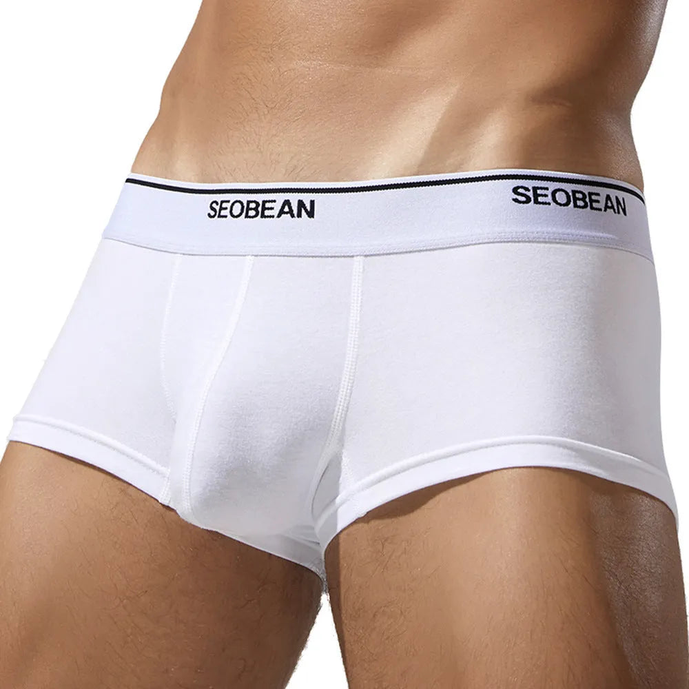 Men's cotton low waist boxer shorts in solid colours on a white background.