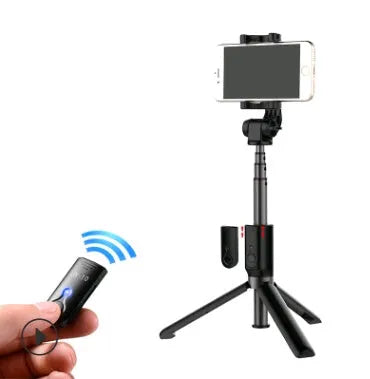 Aluminium Bluetooth selfie stick with tripod base and remote control next to a smartphone