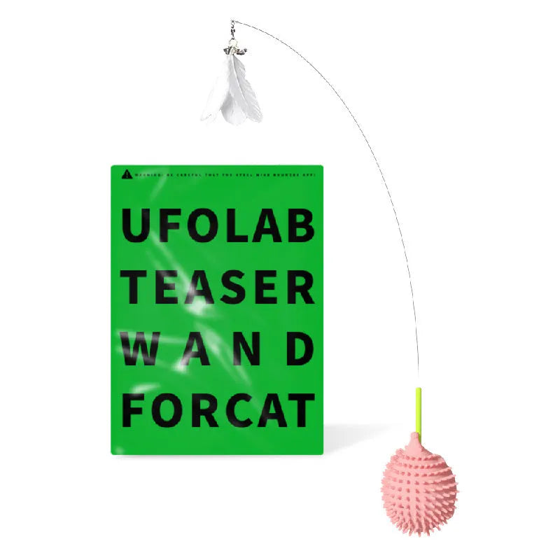 Green plastic cat corner scratcher with a cat teaser stick placed on a wooden floor