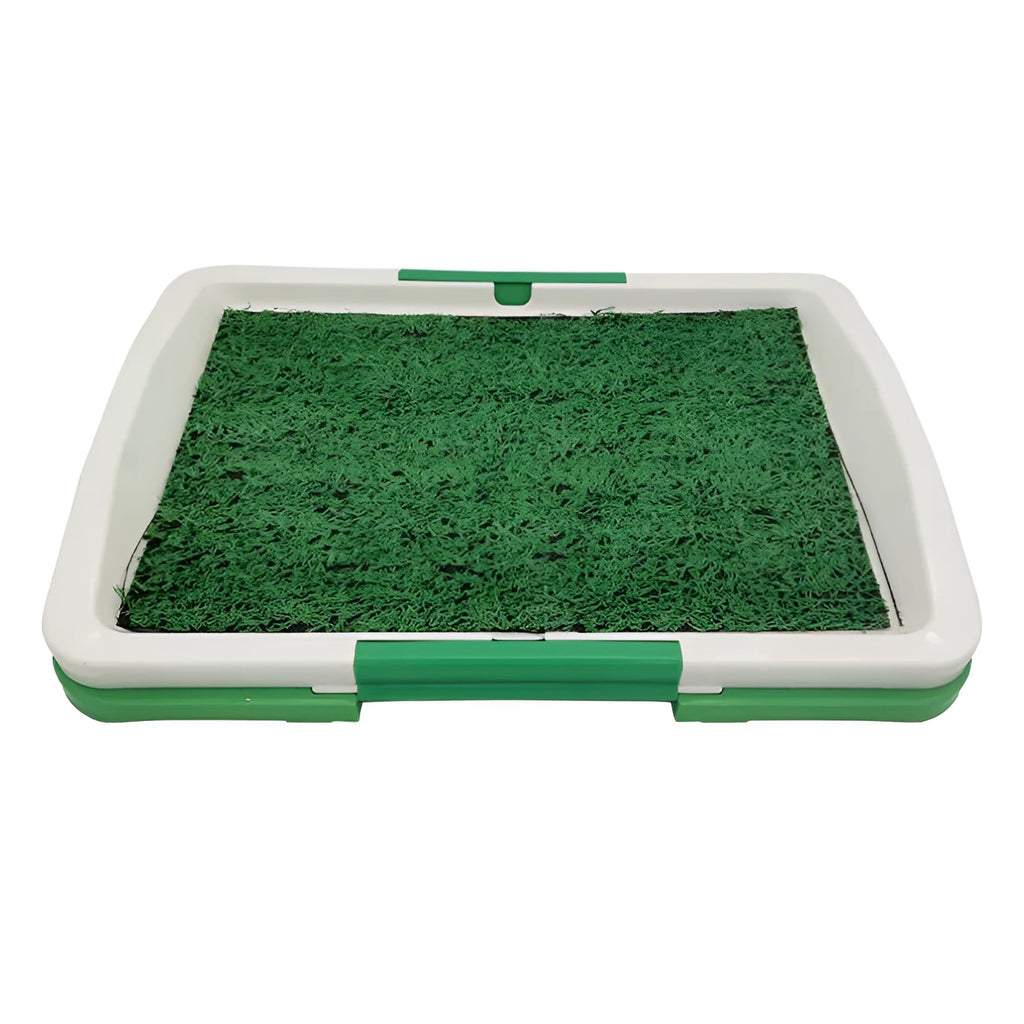 Green artificial grass indoor dog toilet tray with drainage holes and absorbent pads for puppy training.