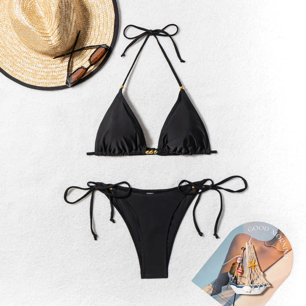 Black women's bikini swimsuit with metal bead detail and split design