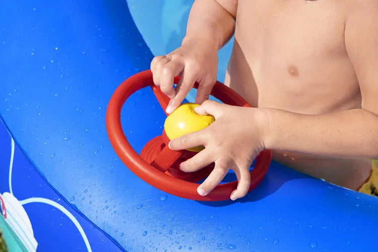 Boat type inflatable PVC sunshade paddling pool for children, 2.13m long, blue with yellow canopy, set up in garden