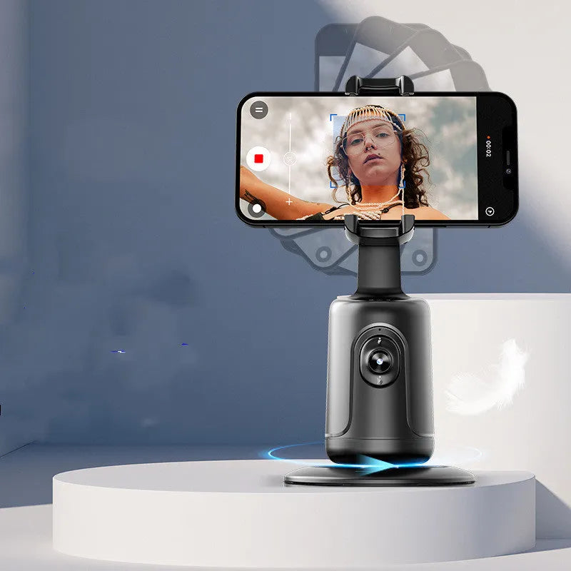 New Automatic Tracking Stabiliser with 360° rotation, ABS body, dark black colour, on a desktop with USB cable
