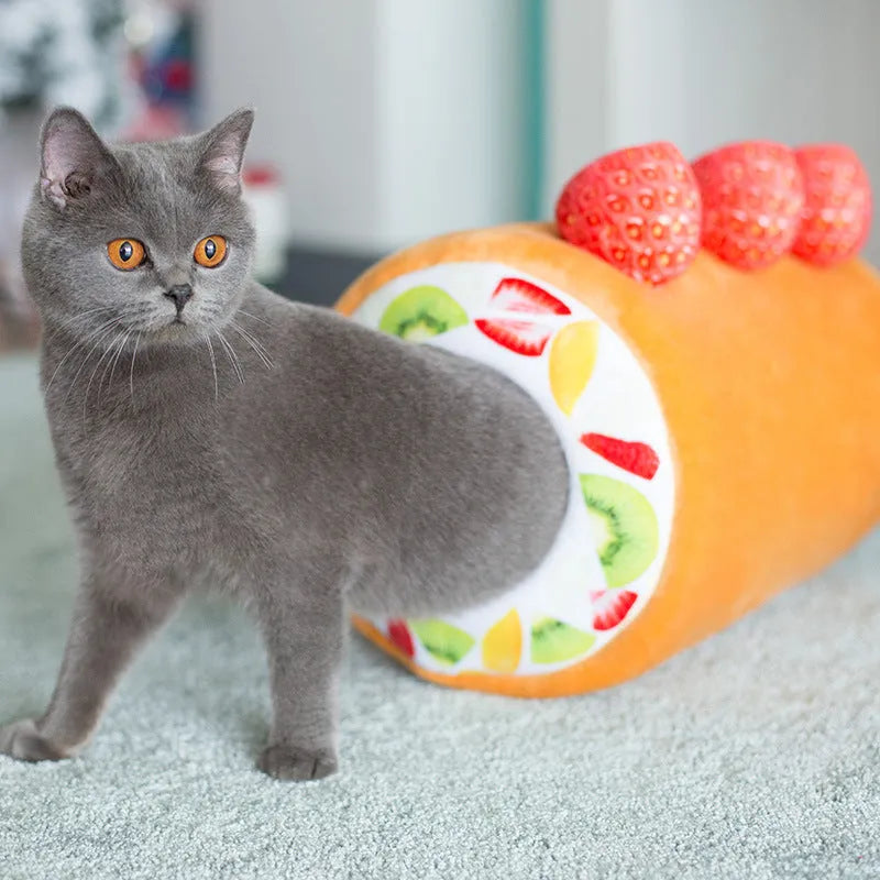 Yellow cake roll shaped plush cat toy with short plush fur on a neutral background
