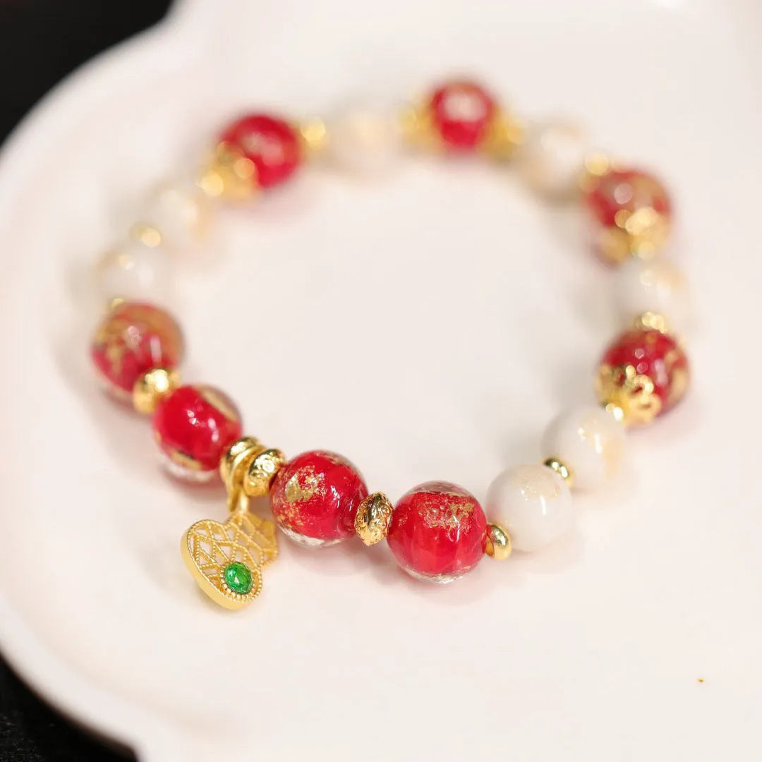 Women's handmade coloured glaze bracelet with gold foil decoration in geometric ethnic style design