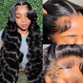 Black synthetic full-head wig with medium-length hair and large, curly waves on a display.