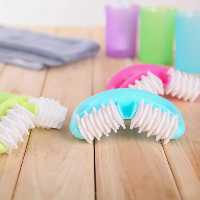 Handheld anti-cellulite massager roller with dot wheels in blue, green, and rose red colours on white background