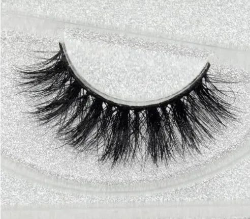 Pair of faux mink eyelashes with long tail and cotton stem against white background