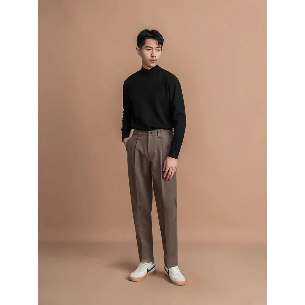 Men's straight-leg casual trousers in draped design, shown in a neutral colour on a hanger.
