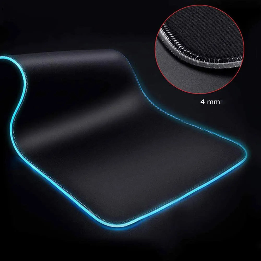 Starry sky pattern RGB luminous gaming mouse pad with USB cable on a desk