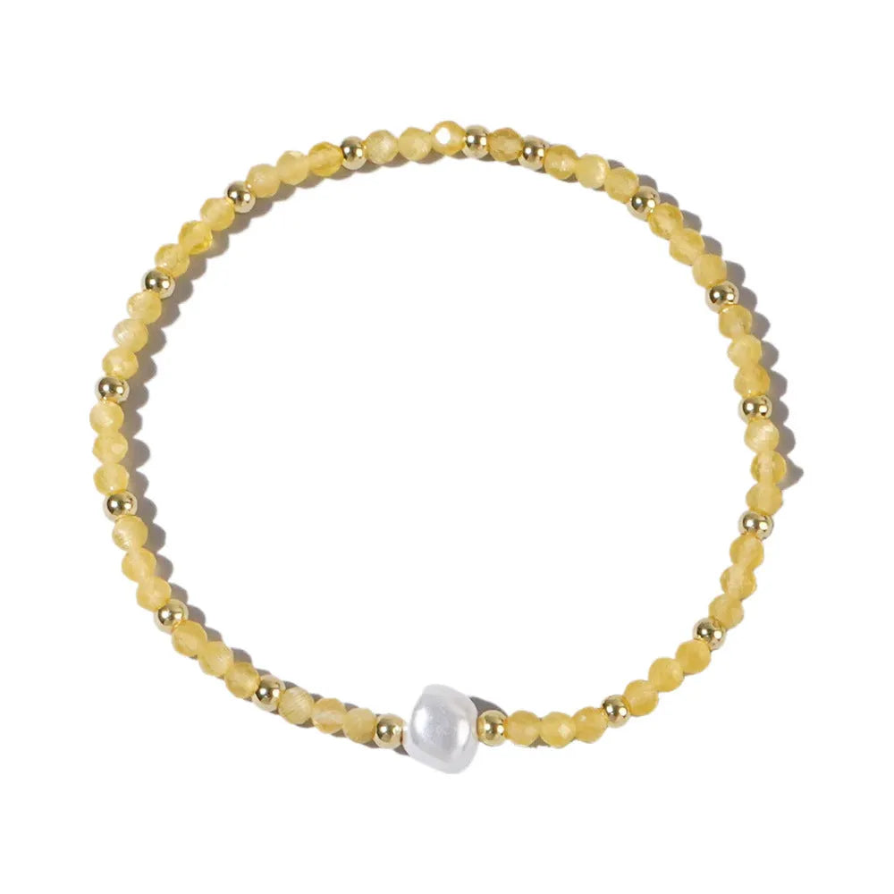Close-up of a unisex natural stone bracelet with geometric ellipse beads on a wrist.