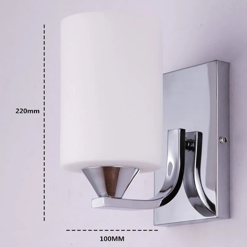 Chrome-finished modern wall lamp with glass shade, shown in single head configuration.
