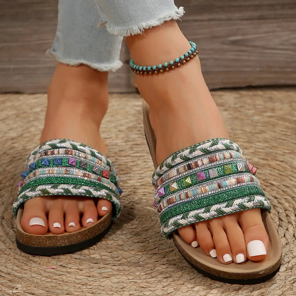 Pair of ethnic style platform slippers with rivet details, featuring linen upper and PVC sole, on a neutral background